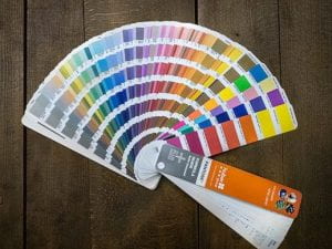 Pantone color swatches fanned out on a desk